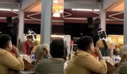 Man walks around with cat perched on his head