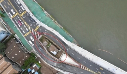 Unyielding house gets wedged between surrounding highway bridge