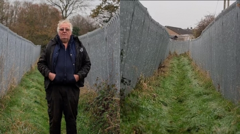 Millionaire farmer builds a 300-ft metal corridor to keep ramblers and dog walkers off his land after a decade
