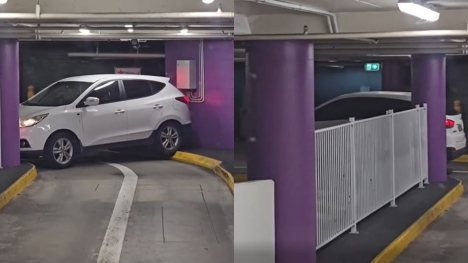 Driver struggles to escape with car trapped in shopping center