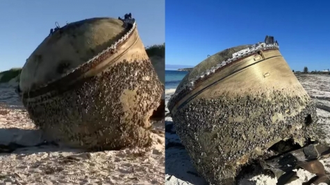 Mysterious cylinder washes up on beach as officials urge public to stay away