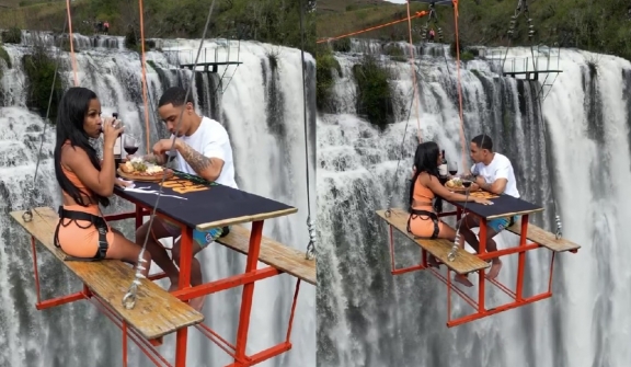 Adventurous couple enjoyed their meal on picnic table suspended 295 feet in the air, leaving people captivated