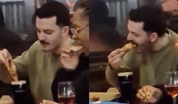 Man was captured dipping Domino's Pizza slice into a pint of Guinness to eat