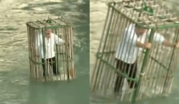 Town punishes unique politicians by putting them in a cage and dropping in the river