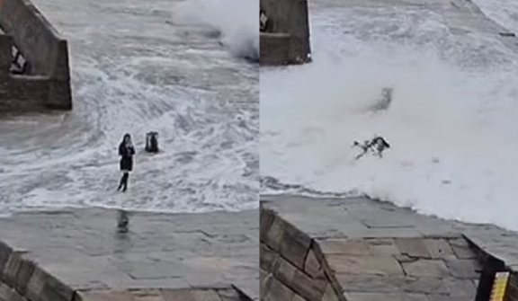 Tourist spotted being swept up by heavy waves in a storm while attempting to take a selfie