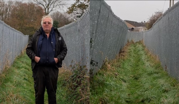 Millionaire farmer builds a 300-ft metal corridor to keep ramblers and dog walkers off his land after a decade