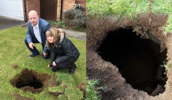 Family baffled after spotting rusty steps lead to mysterious 7ft-deep hole in their lawn 