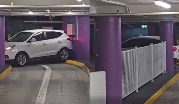 Driver struggles to escape with car trapped in shopping center
