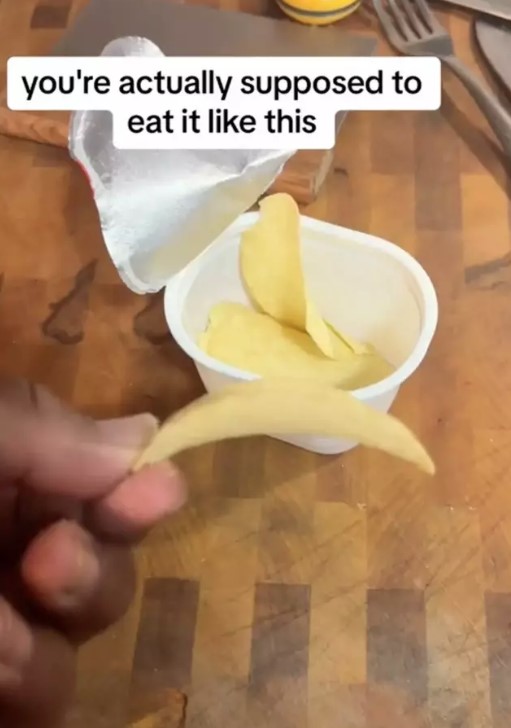 He demonstrates the correct way to enjoy Pringles. Image Credit: TikTok/@cookinhungry