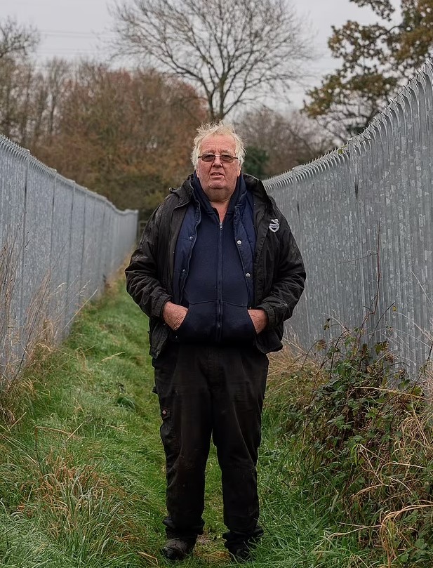 Millionaire farmer builds a 300-ft metal corridor to keep ramblers and dog walkers off his land after a decade 3