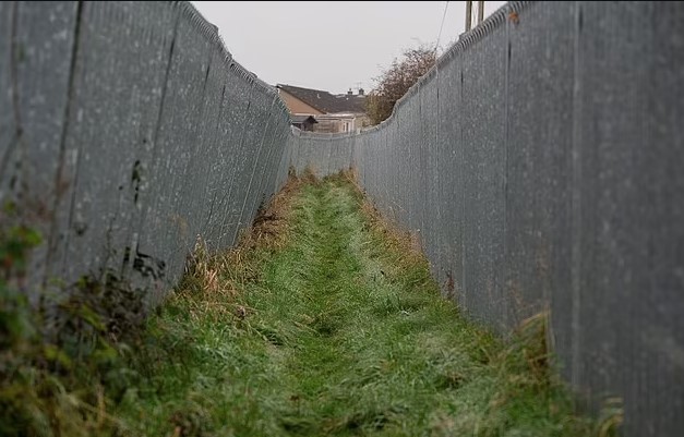 Millionaire farmer builds a 300-ft metal corridor to keep ramblers and dog walkers off his land after a decade 1