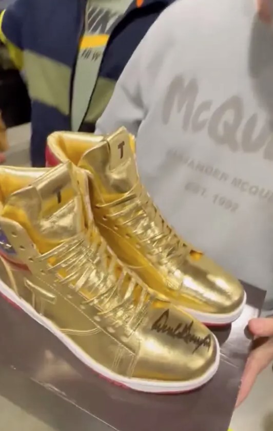 A pair of autographed golden Donald Trump gold shoes sold at auction to a man for a whopping $9,000. Image Credit: X