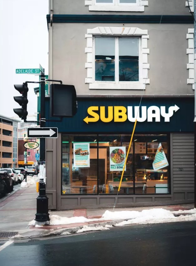 A Reddit user shared an image of a Subway notice board charging customers 10% to pay for workers’ wages. Image Credit: Getty