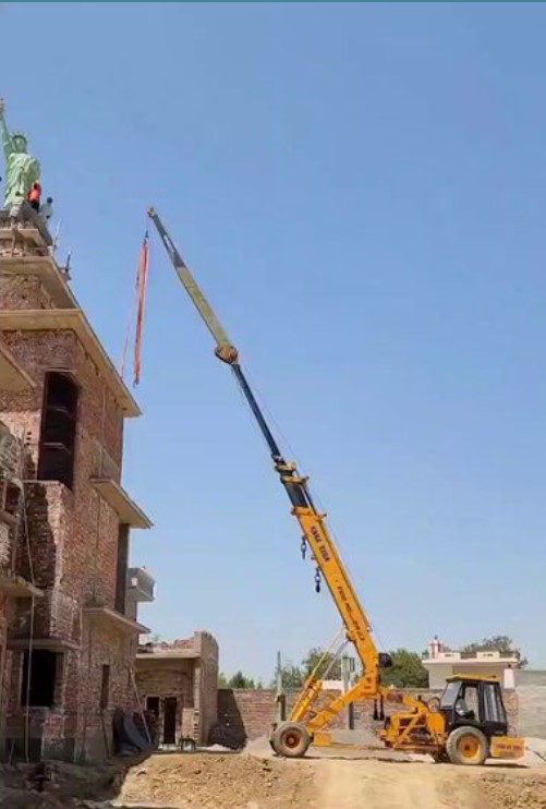 The viral video depicts the installation of the Statue of Liberty replica using a crane and manpower. Image Credit: X