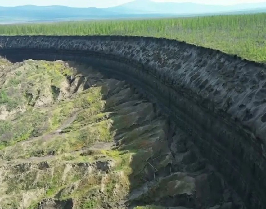 Batagaika Crater's growth impacts not just its surroundings; leaked gases and dirt alter nearby ecosystems like Yana River. Image Credit: NASA