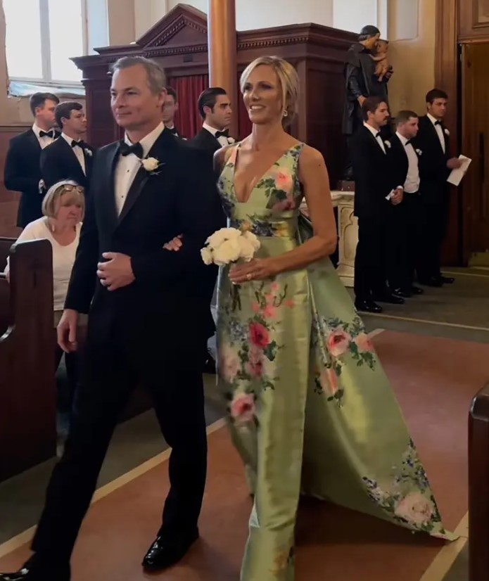 Lori's dress had a low neckline, bow, and train, unlike typical mother-of-the-bride attire. Image Credit: Instagram / @capturedbychloe.co