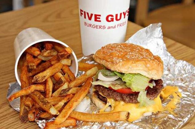 Five Guys serves fries in a larger 24-ounce cup than competitors. Image Credit: Getty