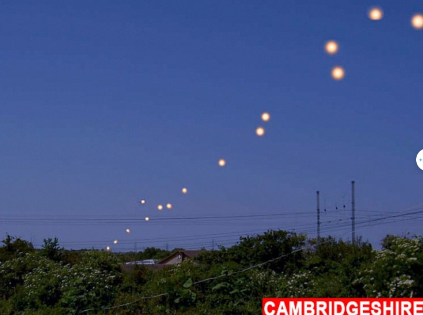 Onlookers baffled after witnessing numerous bizarre orange UFOs floating in the sky 1