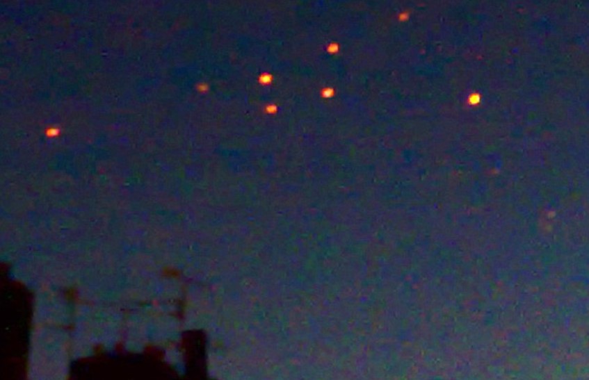 Onlookers baffled after witnessing numerous bizarre orange UFOs floating in the sky 2