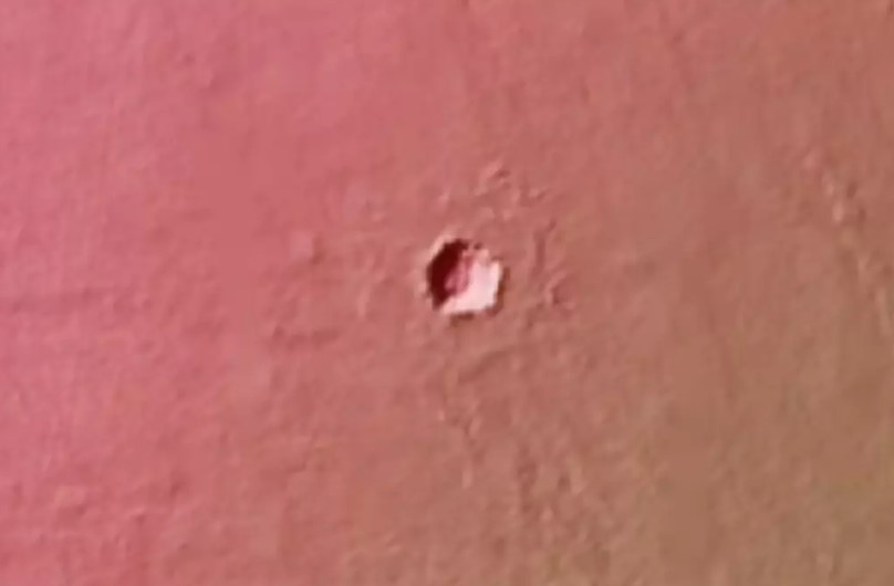 NASA's HiRISE camera captured images of a mysterious hole in the Martian landscape. Image Credit: NASA