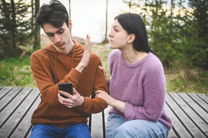 He was protective of his phone and defensive about his texting, prompting her to investigate further. Image Credit: Getty