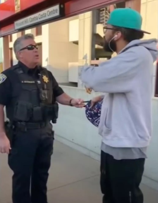 The footage shows an officer grabbing Foster's bag and preventing him from leaving. Image Credit: ABC7 News Bay Area