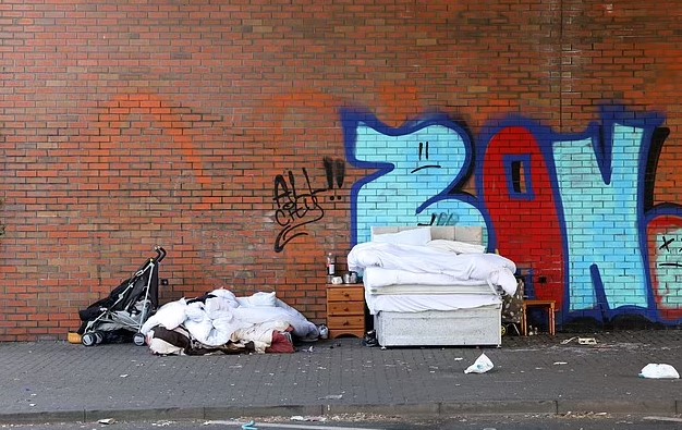 Nada and Ladislav set up a makeshift home on a bed beside a busy roundabout. Image Credit: Media Wales