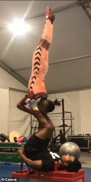 Astounding moment acrobat flips his partner through air with just his feet 1