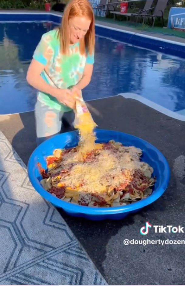 A mother serves a meal to 12 children in a baby pool 2