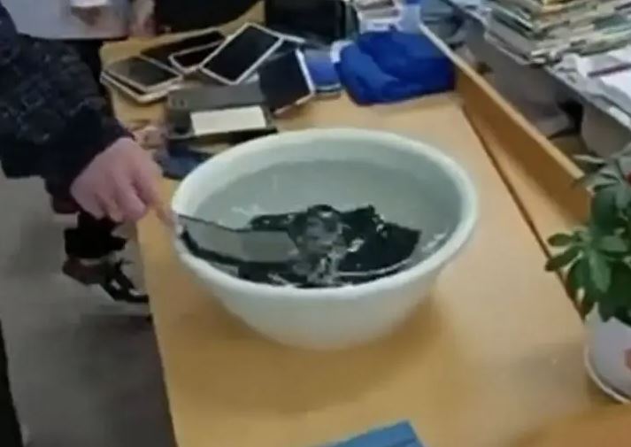 Class teacher soaks students' mobile phones in water for violating school rules 1