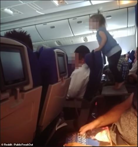 Debate sparks as parents allow toddler to freely roam and play on table during long-haul flight 1