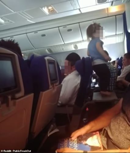 Debate sparks as parents allow toddler to freely roam and play on table during long-haul flight 2