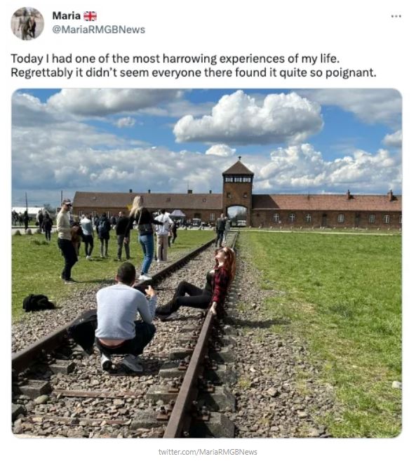 Auschwitz visitor faces spark outrage after posing take a photo on the train tracks 1