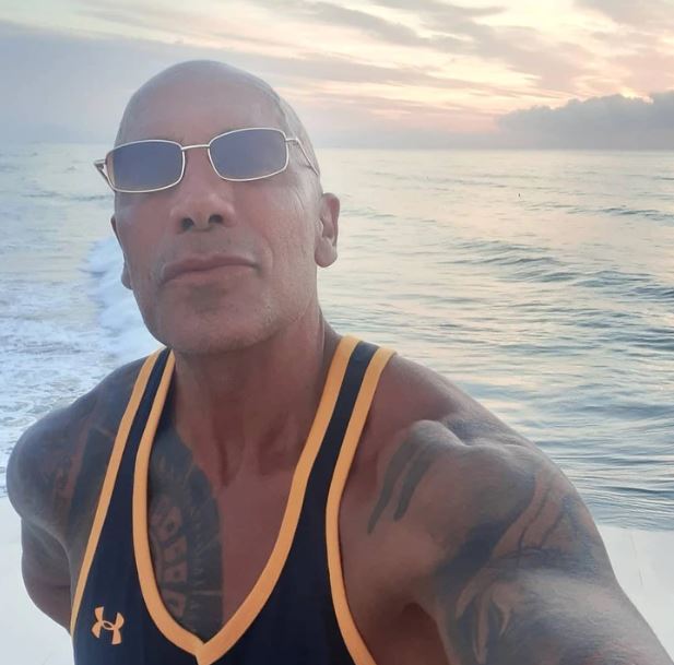 The man looks exactly like The Rock with 50 identical tattoos 2