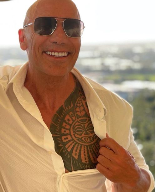 Man looks exactly like The Rock with 50 identical tattoos 4