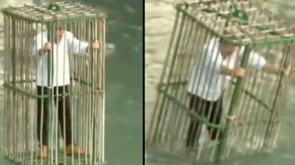 Town punishes unique politicians by putting them in a cage and dropping in the river 1