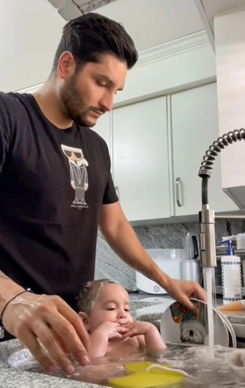 Father is criticized for putting his baby in the kitchen sink and bathing the baby while washing dishes 2