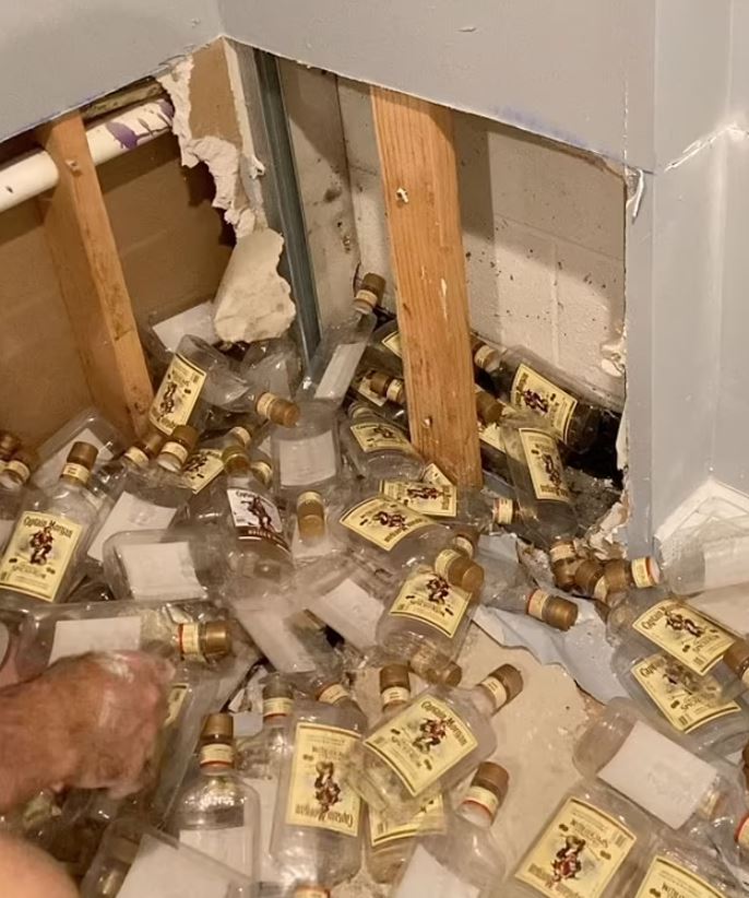 Couple was stunned after finding hundreds of empty rum bottles hidden behind home’s walls 4