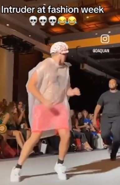 Nobody noticed an imposter wearing a TRASH BAG as he crashed the New York Fashion Week catwalk until security stepped in 2