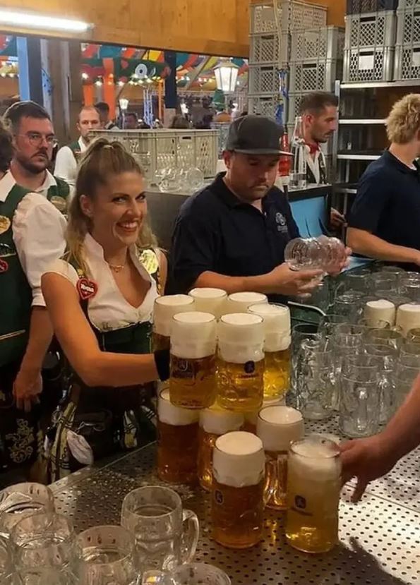 Oktoberfest waitress shows off her super-strength as she carries more than a dozen beers 1