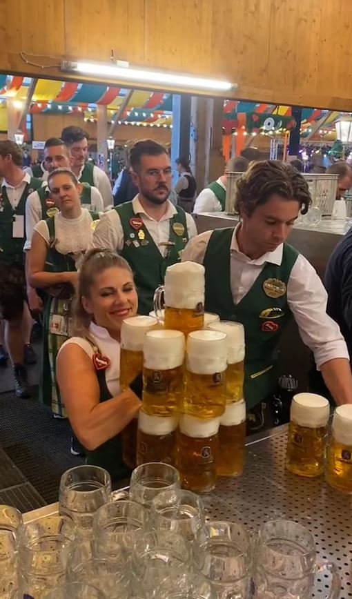 Oktoberfest waitress shows off her super-strength as she carries more than a dozen beers 2