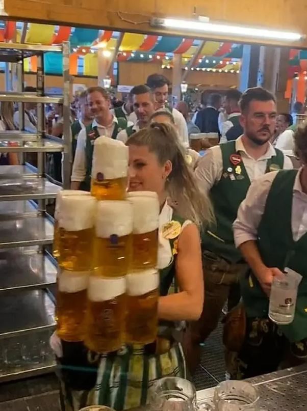 Oktoberfest waitress shows off her super-strength as she carries more than a dozen beers 3
