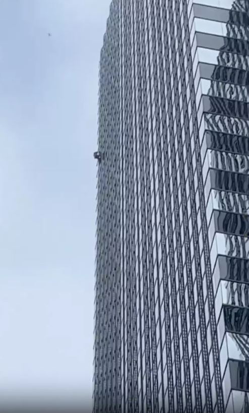 Office workers stunned as 'Pro-life Spiderman' climbs15th-floor window without a rope 4
