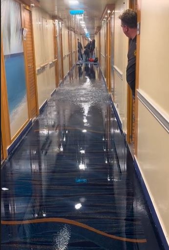 Cruise passengers stunned after waking to find water gushing through the ceiling of a ship 1