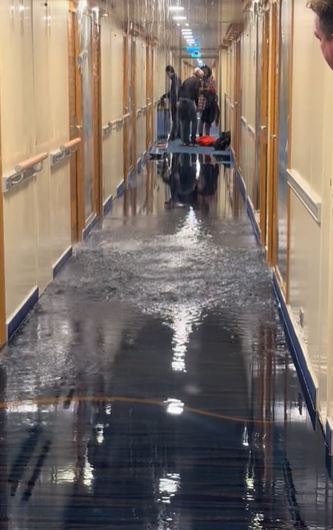 Cruise passengers stunned after waking to find water gushing through the ceiling of a ship 2