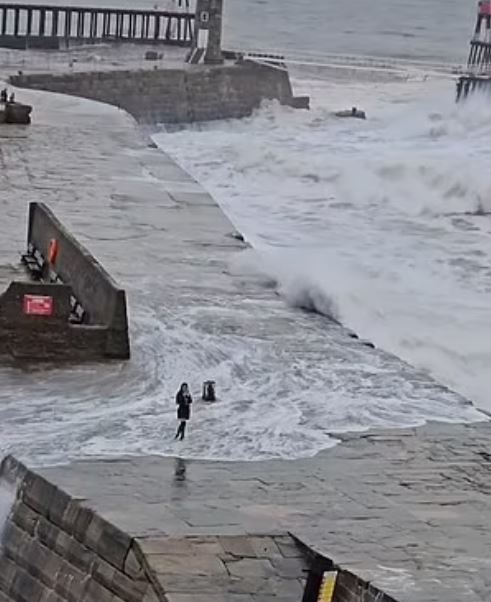 Tourist spotted being swept up by heavy waves in a storm while attempting to take a selfie 1