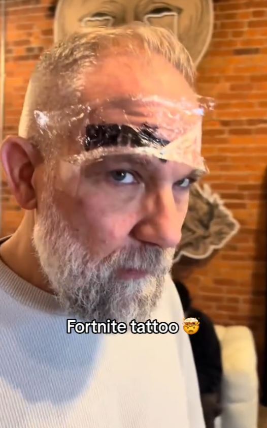 Dad gets a giant Fortnite tattoo on his face after losing a bet with his son 4