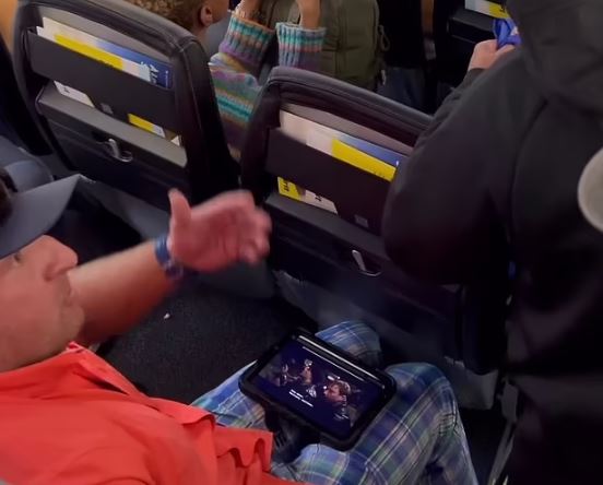 Impatient passenger caught on viral video steps over man next to seat in rush to deplane 4