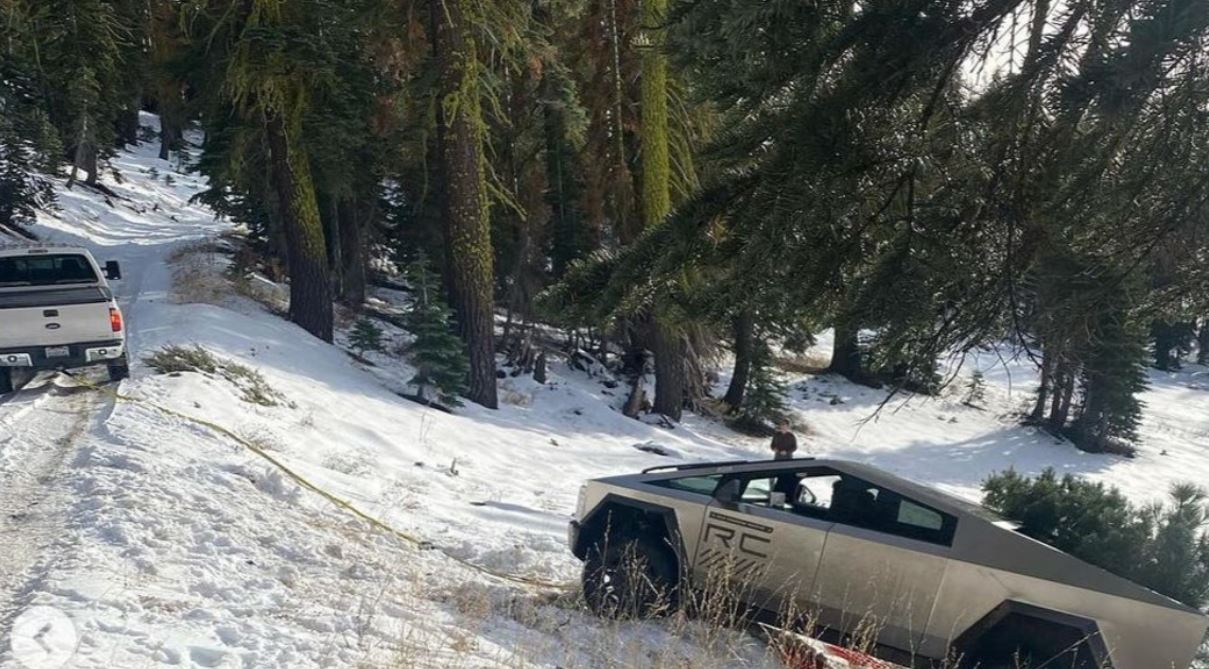 Tesla is getting trolled after Cybertruck pulled to safety after getting stuck on a snowy embankment. Image Credits: Twitter