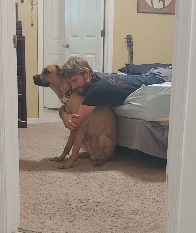 Caught him hugging the giant dog he didn't want, he was also singing the dog his own personal song.  